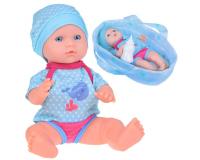 Imádnivaló játékbaba kék ruhában hordozóval, cumisüveggel